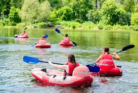 a group of people riding on the back of a boat in the water