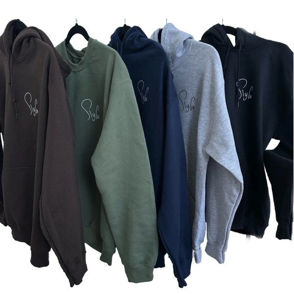 Five hoodies in brown, green, navy, gray, and black with subtle logo hung on hangers.