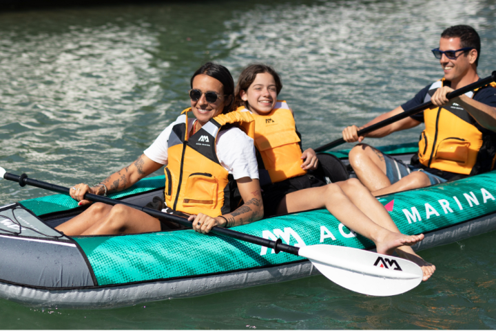 a group of people rowing a boat in a body of water