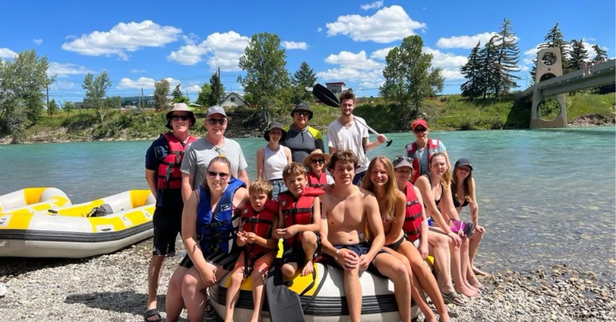 a group of people on a beach posing for the camera