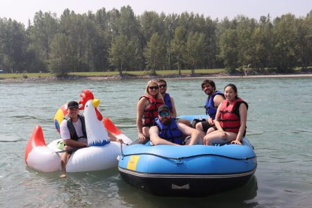 a group of people riding on the back of a boat in the water