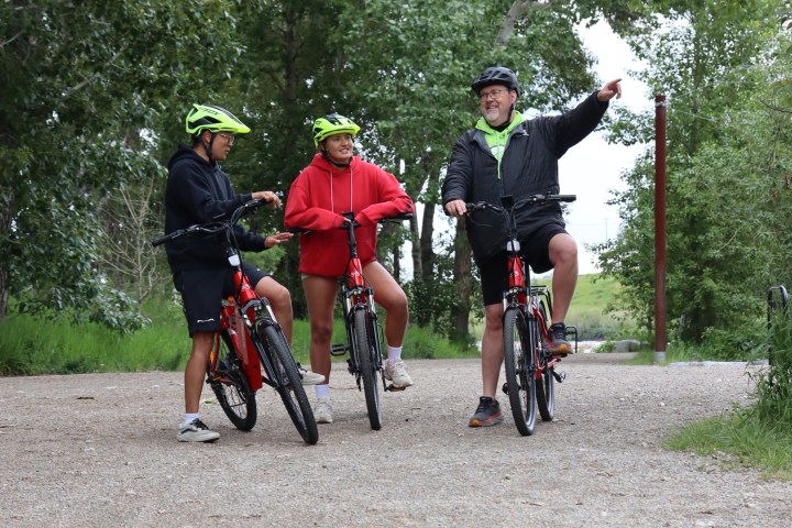 a group of people riding on the back of a bicycle