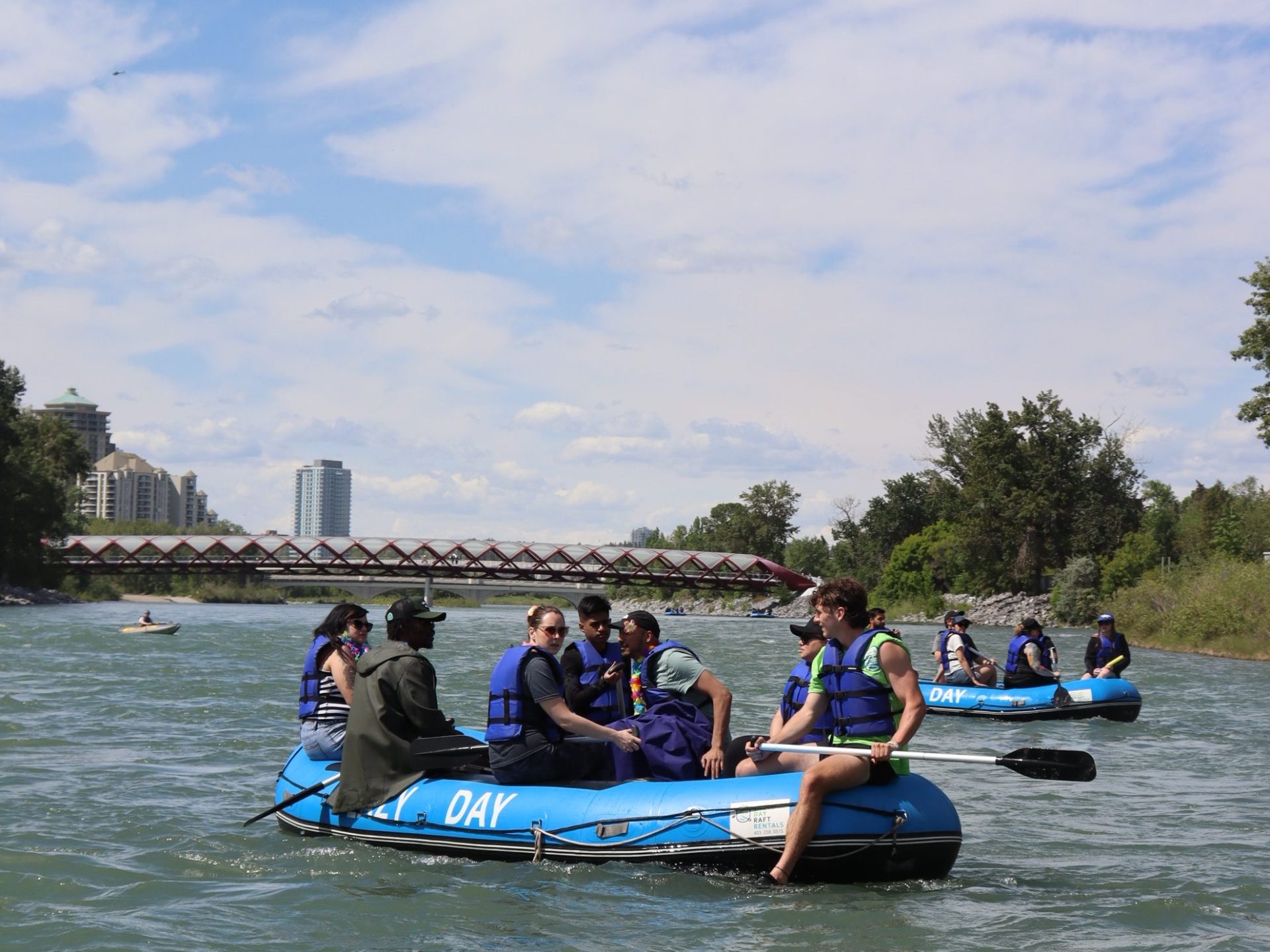 a group of people riding on the back of a boat in the water