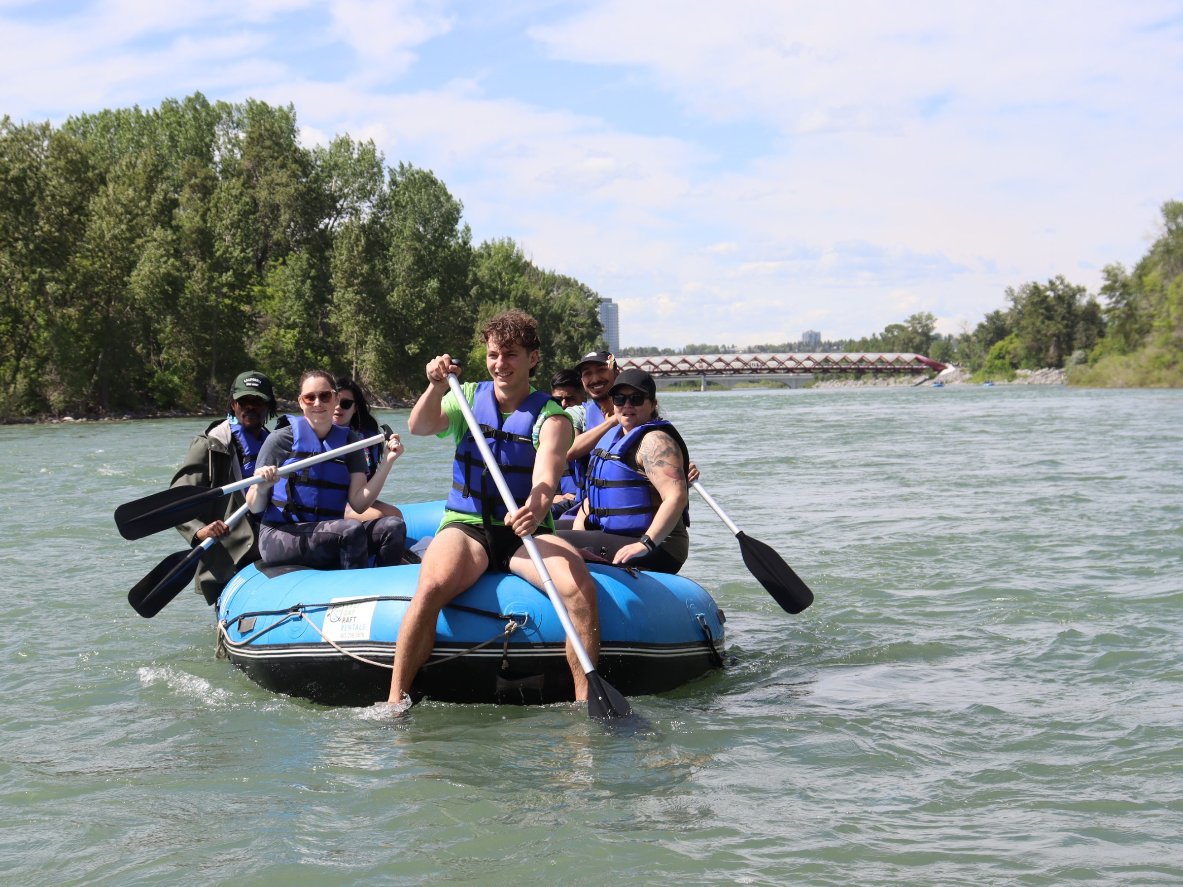 a group of people riding on the back of a boat in the water