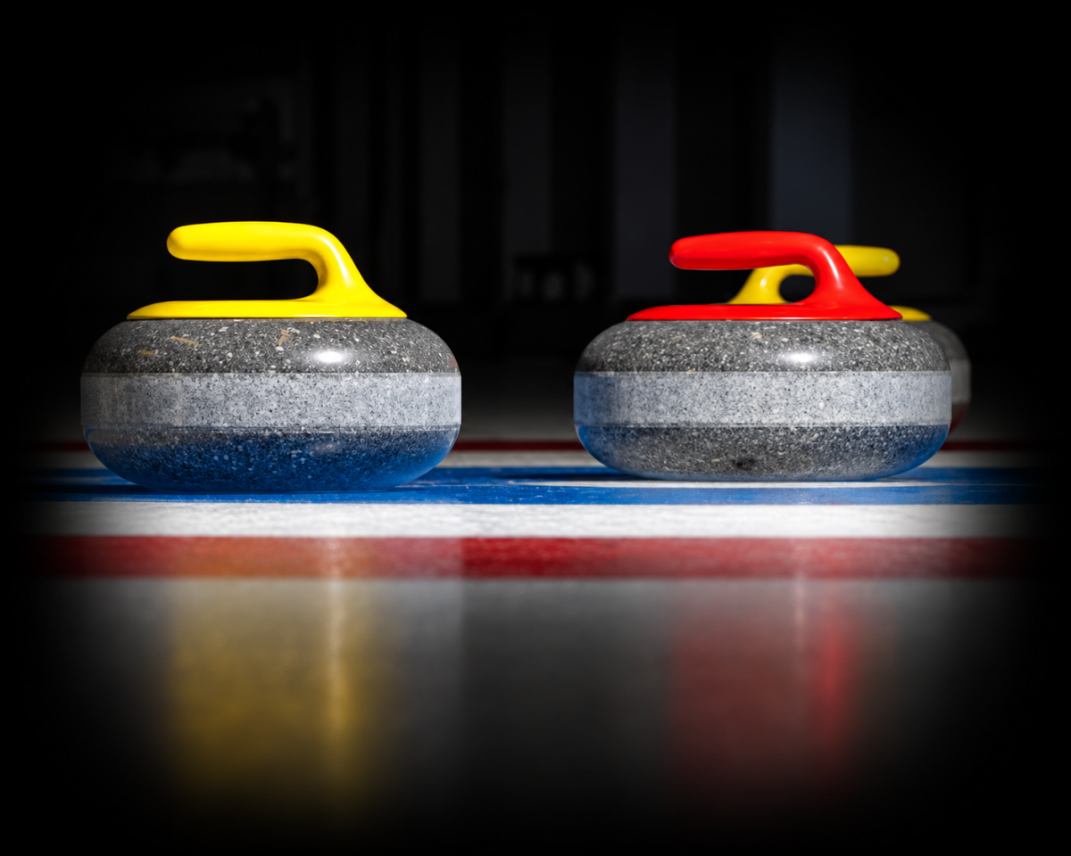 Two curling stones with yellow and red handles on ice.